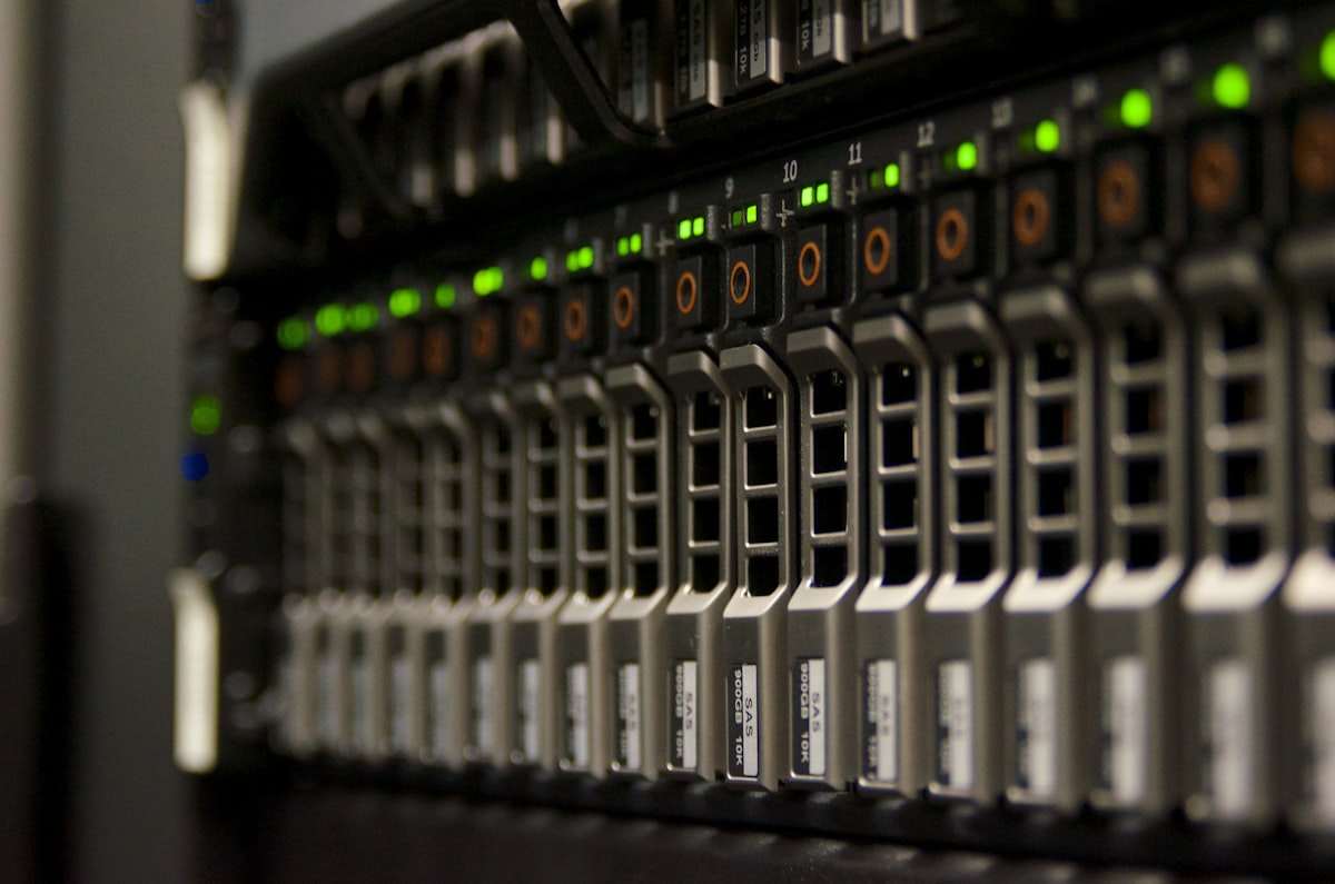 Close-up of server rack hardware with green indicator lights in a data centre